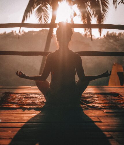 Woman sitting on a deck in the sun